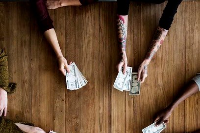 Friends pooling cash together